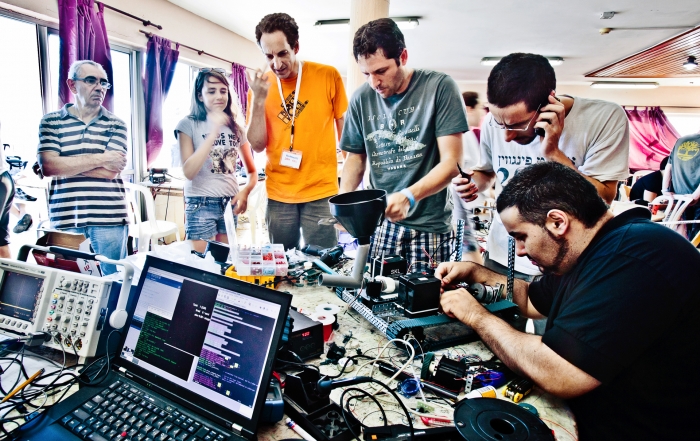 Hackers stand around their project at Geekcon 2011, Israel
