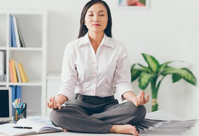 Woman in lotus position at work