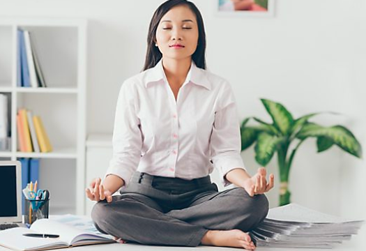 Woman in lotus position at work