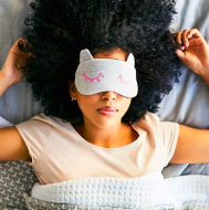 Woman in bed wearing an eye mask
