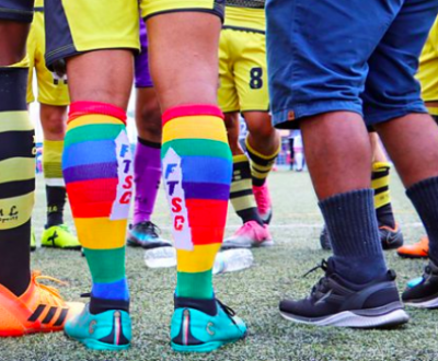 Footballer wearing rainbow-coloured socks