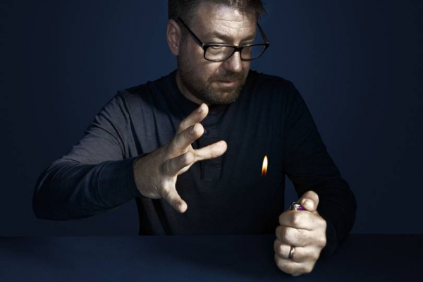 Gustav Kuhn performing a magic trick with a lighter