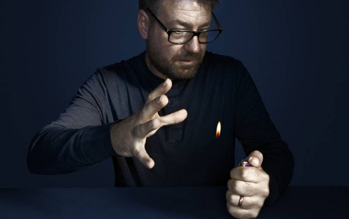 Gustav Kuhn performing a magic trick with a lighter