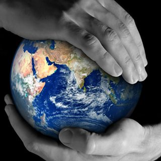 Picture of two hands holding a globe of the Earth