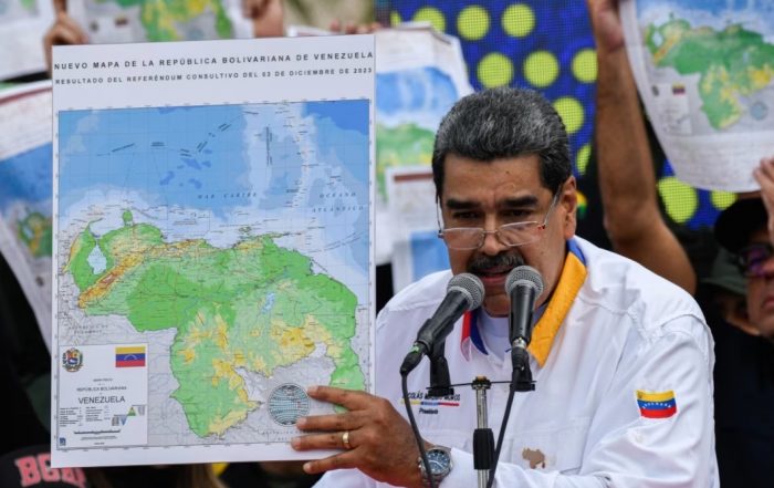 President Maduro of Venezuela holding up a map showing Venezuela's claim on Guyana's Essequibo region.