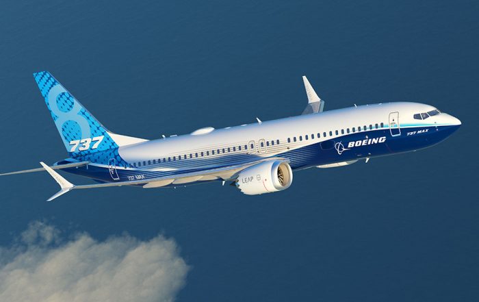 A blue and white Boeing 737 Max in flight against a blue sky