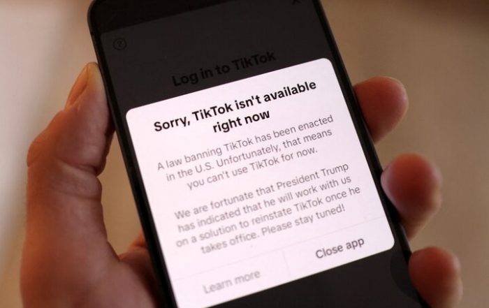 A phone screen showing TikTok unavailable in the US.